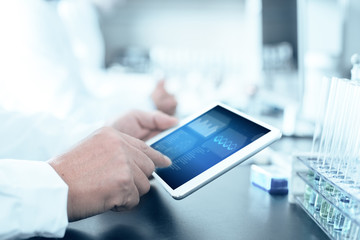 people analysis chemical experiment by tablet in modern lab