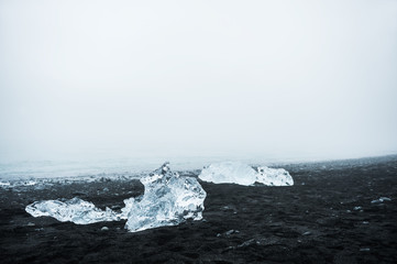 Icebergs on the beach with black volcanic sand in Iceland