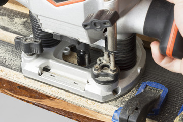 Plunge router making a groove on wood