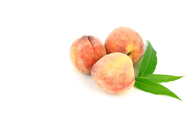 peach fruits with  green leaves isolated on white background