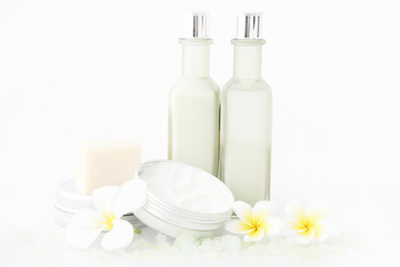 Set of different cosmetic product with frangipani flowers