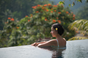 Young woman in the pool in a villa in the village of Ubud, Indonesia