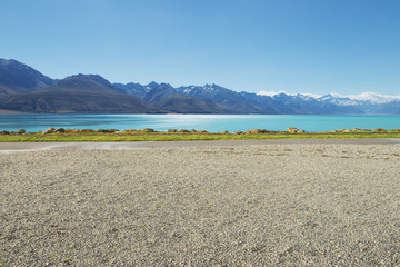 empty rural road near lake and snow mountain in new zealand - 107307176