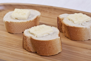 three slices of baguette bread with butter