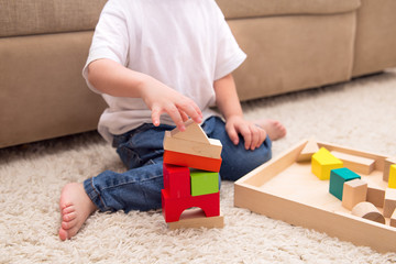 kid plays with cubes