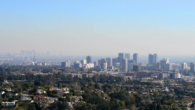 Downtown Los Angeles skyline over blue cloudy sky