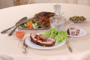 pork stuffed with vegetables and a decanter of vodka