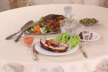 pork stuffed with vegetables and a decanter of vodka