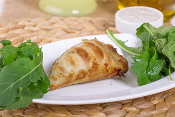 Plate of stuffed cuttlefish inside cheese, mushroom and seafood serving with aubergine salad