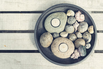 Tealights with pebbles and seashells