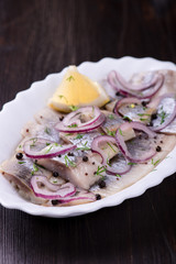 Sliced herring with pepper, herbs, salt, onion