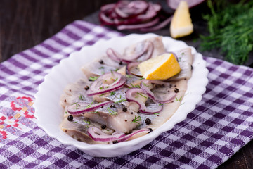 Herring salad with onion and herbs and lemon
