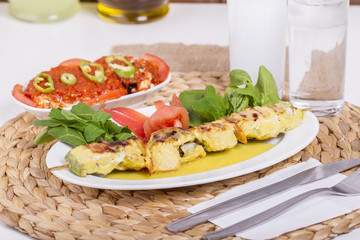 Whiting Fish Skewer on White Plate with Salad and Turkish Traditional Alcohol Drink Raki , Ouzo