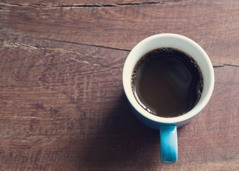 Obraz na płótnie Canvas cup of coffee on wooden table closeup