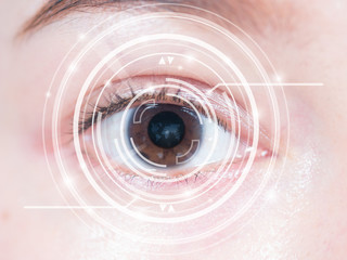 Close-up of woman's brown eye. High technology in the futuristic