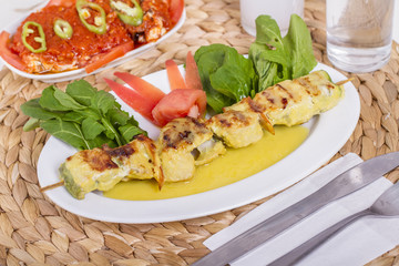 Whiting Fish Skewer on White Plate with Salad and Turkish Traditional Alcohol Drink Raki , Ouzo