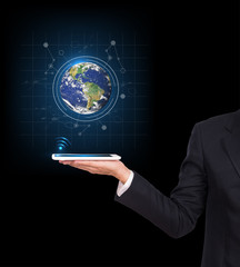 Businessman hands holding tablet with Earth planet. Elements of