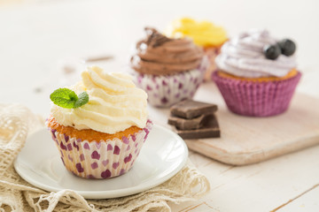 Selection of colorful cupcakes, white background