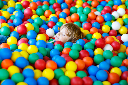 Child Playing At Colorful Plastic Balls Playground 