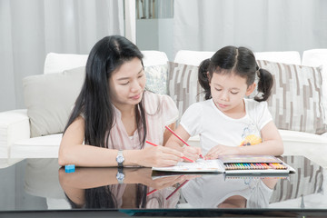 mother and daughter drawing at home