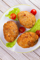 Scotch Eggs Served with Tomato Cherry and Salad on White Plate. View From Above, Top Studio Shot