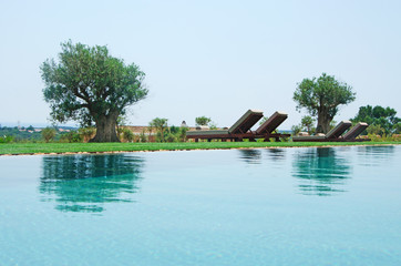 Minorca, Isole Baleari, Spagna: sedie a sdraio, piscina e alberi nella campagna minorchina il 6...