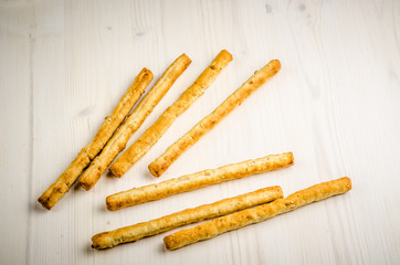 rustic breadsticks on wood table, close up, background.