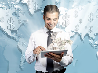 Financial concept. Make money on the Internet. Handsome businessman holding tablet on world map background