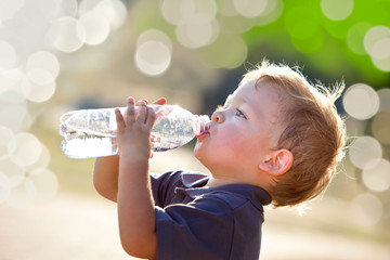 beautiful blonde child drink water outdoor - obrazy, fototapety, plakaty