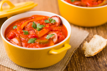 Delicious letcho with fresh vegetables, served in a yellow pot w