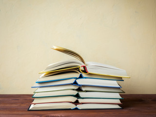 Pile of open books lying on the table