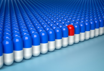 Concept of uniqueness. Red capsule in row of blue capsules