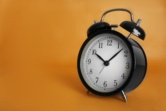 Alarm clock on brown background.