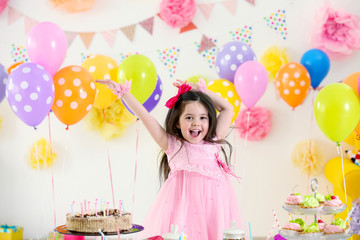 Obraz na płótnie Canvas Happy cute little girl having fun at birthday party