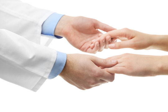 Male doctor holding patient's hand, isolated on white