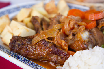 baked meat with potato and rice on dish