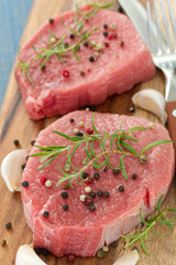 raw meat with pepper and garlic on wooden board