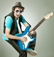 funny guitar player in concert isolated on grey