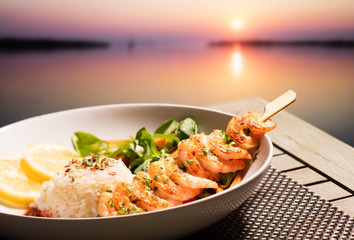 Shrimp skewers and sunset at sea
