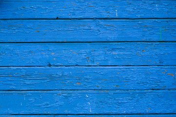 Obraz premium Old blue cracked paint on the old wooden background