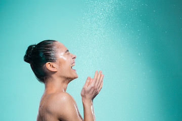 Woman enjoying water in the shower under a jet - obrazy, fototapety, plakaty