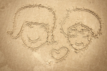 man and women drawing on the sand , orange color
