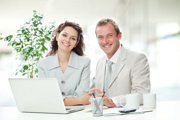 beautiful couple of businesswoman and businessman working with laptop at office