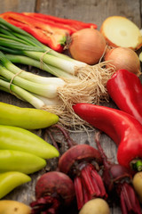 Various fresh raw vegetables on wooden surface