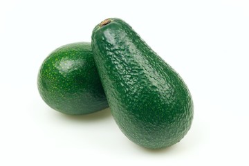 Two avocado fruits, on white background.