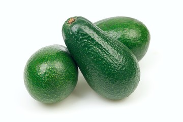 Three avocado fruits, on white background.