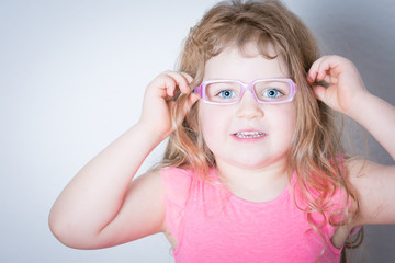 portrait of a three year old girl with eyeglasses
