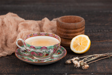 Tea with  lemon and primroses on the table