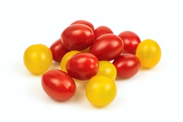 Red and yellow cherry tomato stack, on white background.
