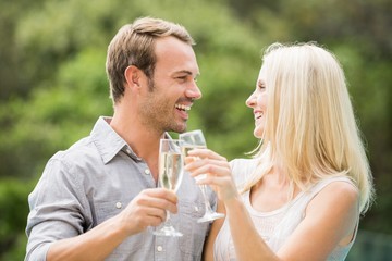 Smiling couple toasting champagne flutes